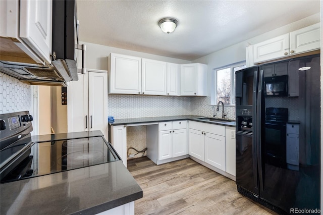 kitchen featuring sink, light hardwood / wood-style flooring, white cabinetry, electric range, and tasteful backsplash