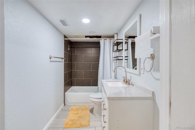 full bathroom with shower / tub combo with curtain, vanity, and toilet