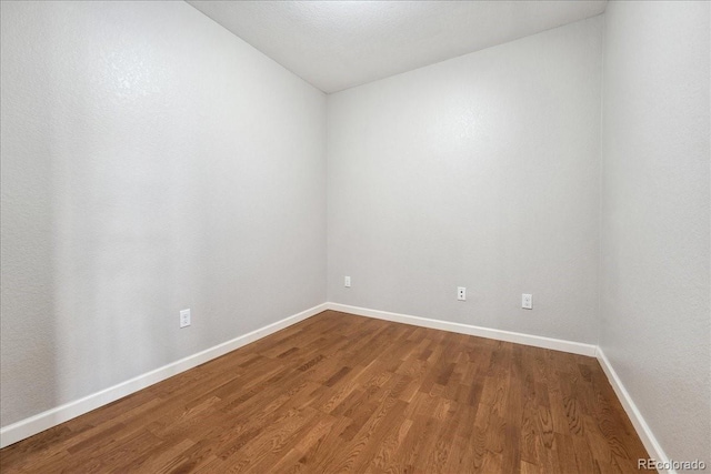 empty room featuring hardwood / wood-style flooring