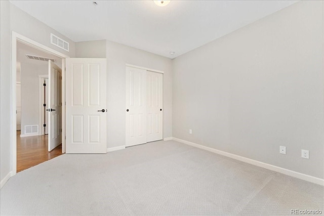 unfurnished bedroom with carpet floors and a closet