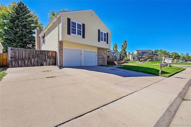 view of side of home featuring fence, an attached garage, concrete driveway, a lawn, and brick siding