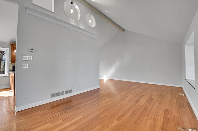 interior space featuring beam ceiling, light wood-style flooring, baseboards, and visible vents