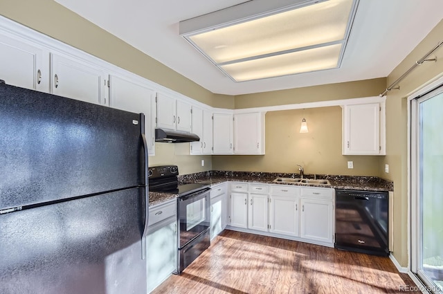 kitchen featuring dark stone counters, sink, black appliances, dark hardwood / wood-style floors, and white cabinetry