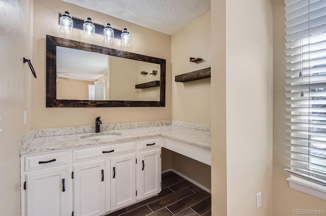 bathroom with vanity and a textured ceiling