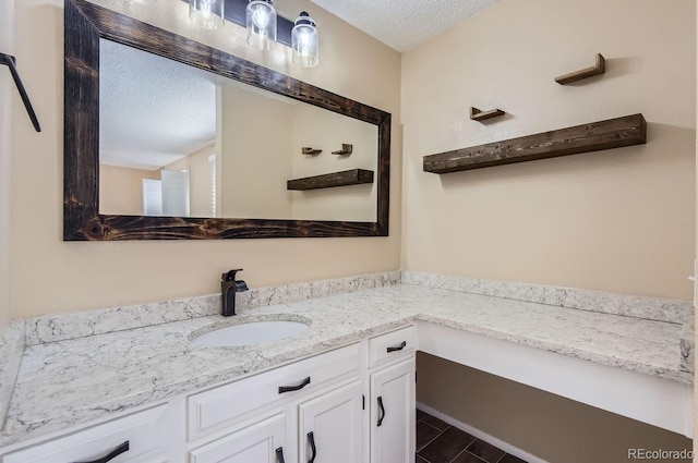 bathroom featuring vanity and a textured ceiling