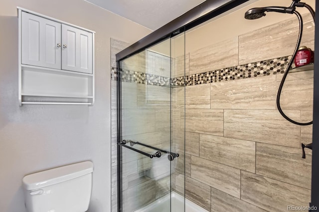 bathroom with toilet and an enclosed shower