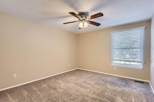 carpeted empty room with ceiling fan and a textured ceiling