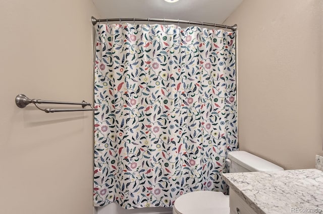 bathroom with vanity, a shower with shower curtain, and toilet