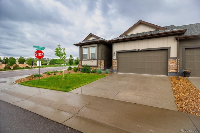 view of front of house with a garage and a front lawn