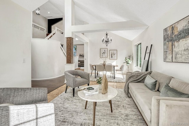 living room with wood finished floors, high vaulted ceiling, stairs, a textured ceiling, and a notable chandelier