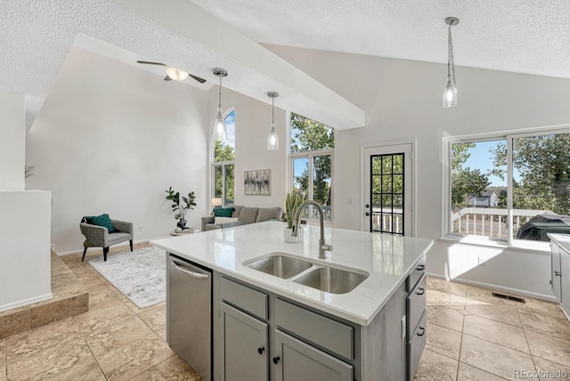 kitchen featuring a sink, open floor plan, pendant lighting, gray cabinets, and stainless steel dishwasher