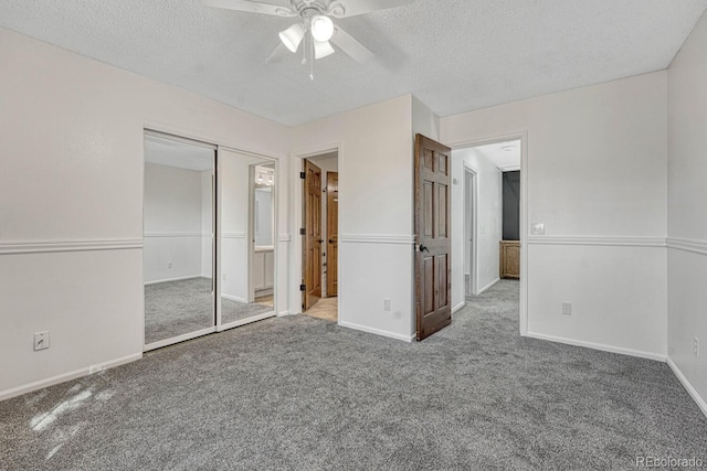 unfurnished bedroom featuring baseboards, ceiling fan, carpet, ensuite bath, and a textured ceiling