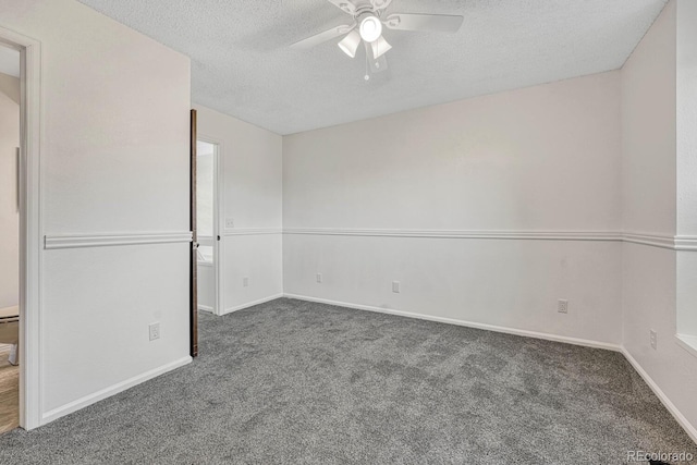 unfurnished bedroom featuring baseboards, carpet floors, a textured ceiling, and a ceiling fan