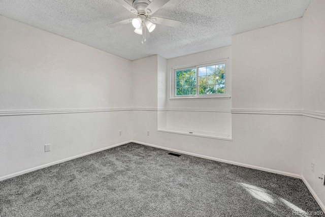 spare room with visible vents, baseboards, ceiling fan, carpet floors, and a textured ceiling