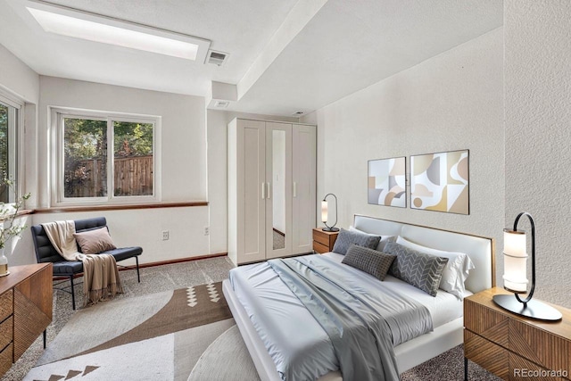 bedroom with carpet flooring, baseboards, and visible vents