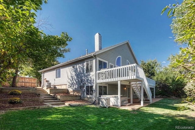 back of property with stairway, a yard, and a chimney