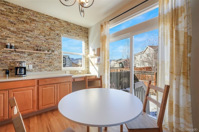 dining room with light wood-type flooring and a notable chandelier