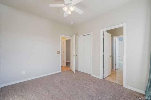 unfurnished bedroom featuring ceiling fan, light carpet, and a closet