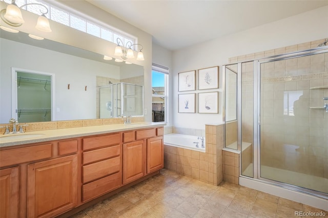 bathroom with plus walk in shower, plenty of natural light, and vanity