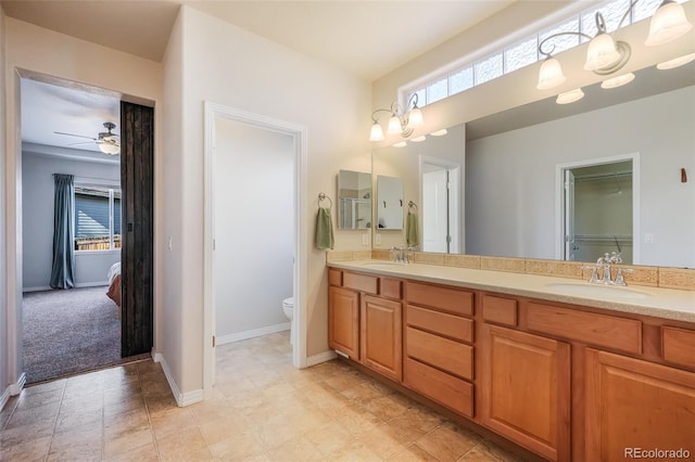 bathroom featuring ceiling fan, toilet, and vanity