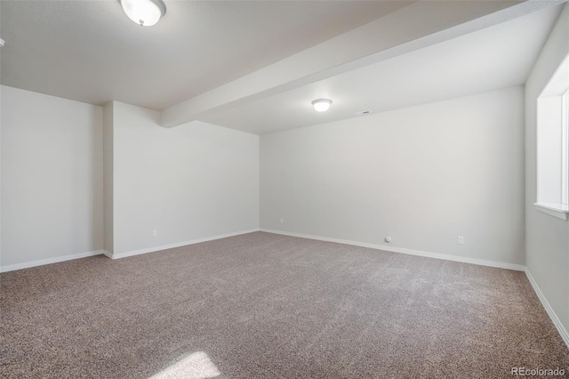 carpeted empty room with beamed ceiling