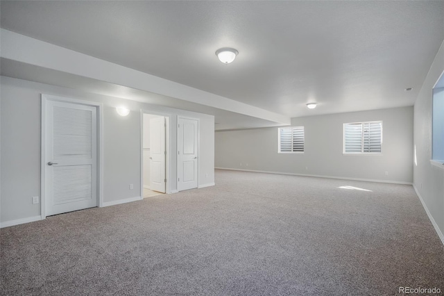 basement featuring light colored carpet