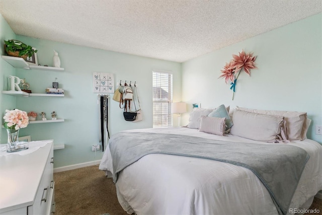 bedroom with baseboards, carpet flooring, and a textured ceiling