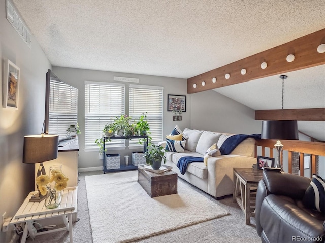 living area with a textured ceiling, visible vents, and carpet