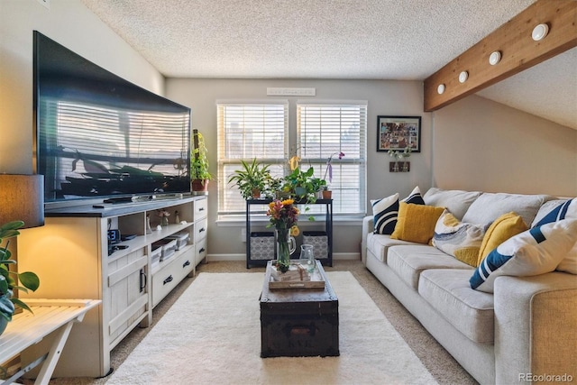 living area featuring a textured ceiling, light carpet, baseboards, and beam ceiling