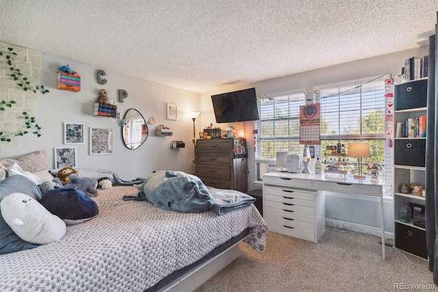 bedroom featuring carpet flooring and a textured ceiling