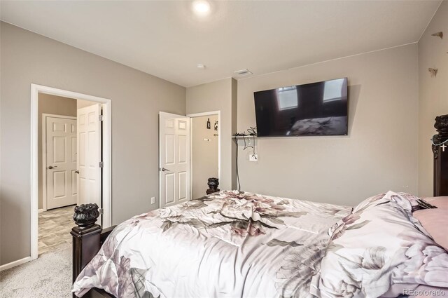 carpeted bedroom featuring baseboards