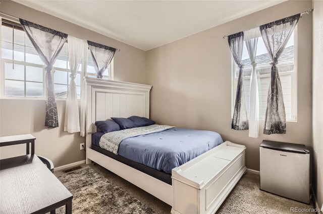 bedroom with fridge and baseboards