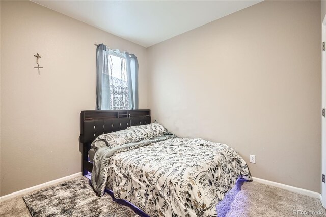 carpeted bedroom featuring baseboards