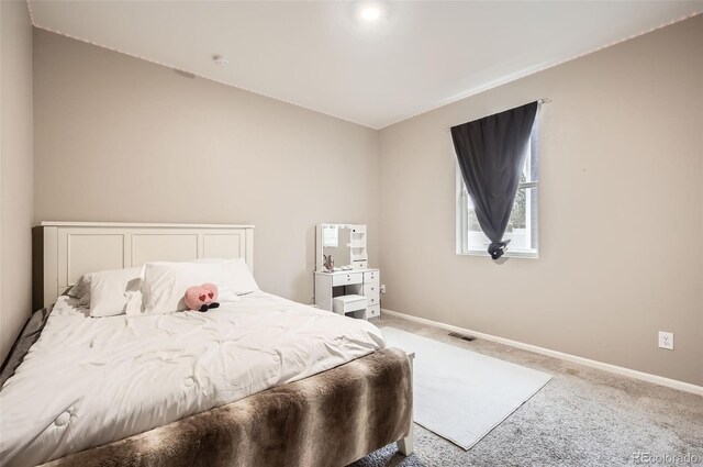 carpeted bedroom featuring baseboards