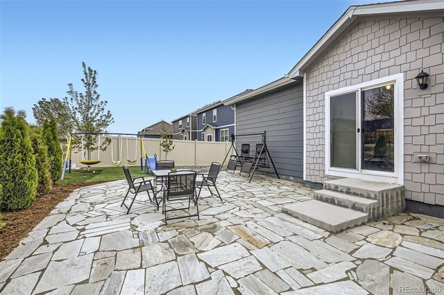 view of patio with fence and outdoor dining area