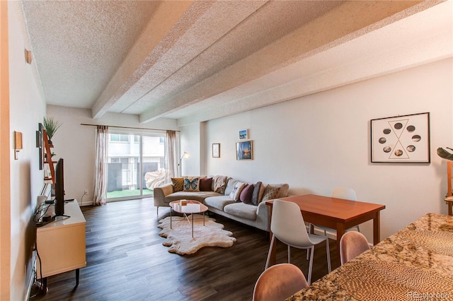 living area featuring beam ceiling, dark wood finished floors, and a textured ceiling