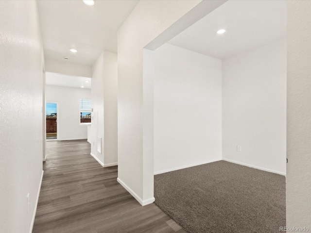 hall featuring dark wood-style floors, recessed lighting, and baseboards