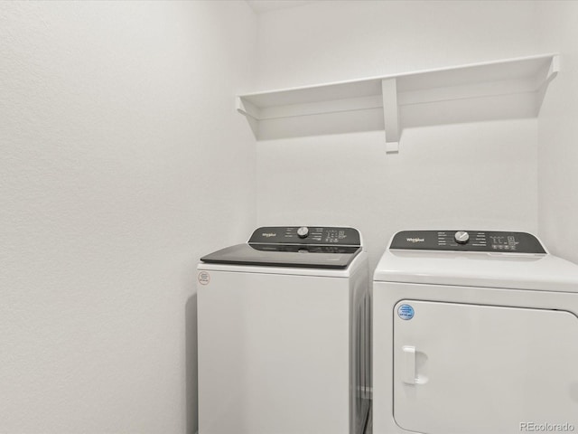 washroom with washer and clothes dryer and laundry area