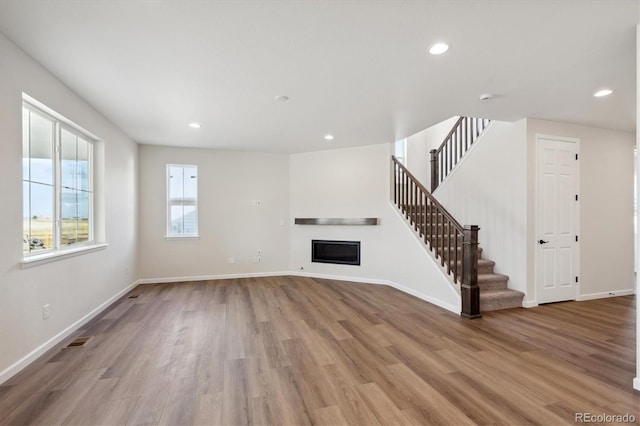 unfurnished living room featuring light hardwood / wood-style floors