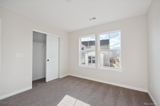 unfurnished bedroom featuring a closet and carpet