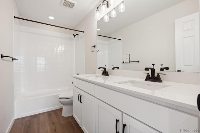 full bathroom with toilet, shower / bath combination, vanity, and hardwood / wood-style floors