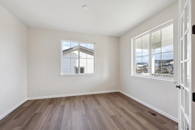 unfurnished room featuring hardwood / wood-style flooring