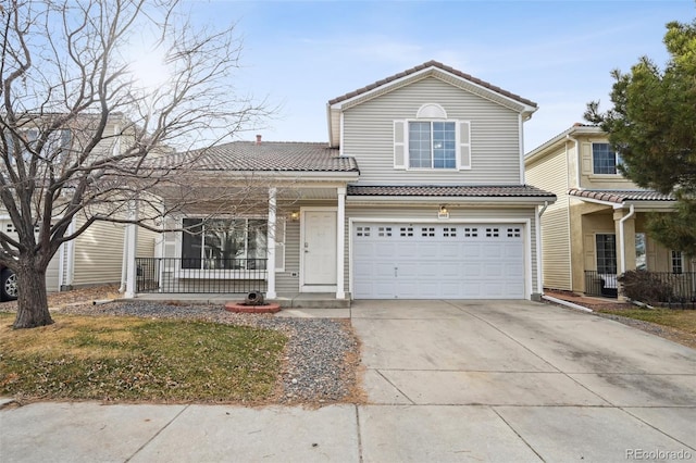 traditional home with a garage, a porch, driveway, and a tile roof