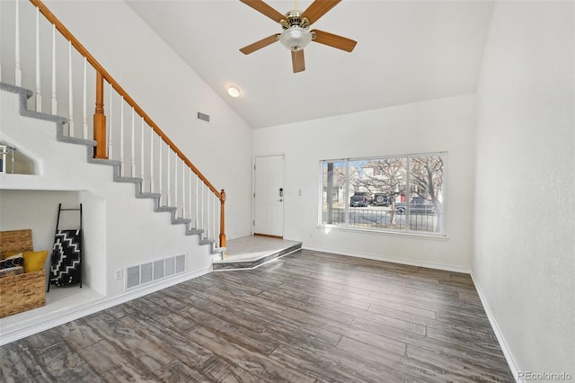 foyer featuring visible vents, wood finished floors, a ceiling fan, and stairway