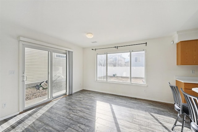 interior space with wood finished floors and baseboards