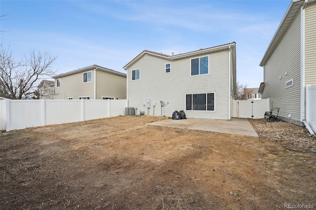 rear view of property with a patio, a gate, central AC unit, and a fenced backyard