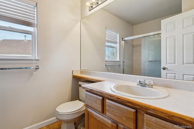 10358 Kelliwood Way, Highlands Ranch, CO 80126 - bathroom with vanity, a shower with door, baseboards, and toilet