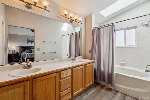 10358 Kelliwood Way, Highlands Ranch, CO 80126 - ensuite bathroom featuring shower / bath combination with curtain, wood finished floors, double vanity, a skylight, and lofted ceiling