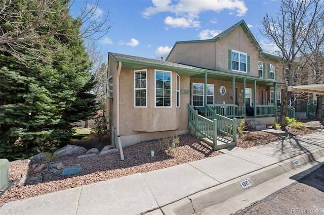 6087 Colony Cir, Colorado Springs, CO 80919 - view of front of house with covered porch and stucco siding