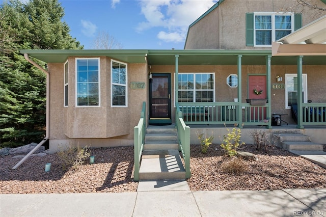 6087 Colony Cir, Colorado Springs, CO 80919 - view of front of property featuring a porch and stucco siding